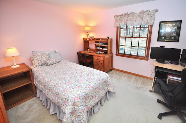 bedroom with light carpet and baseboards