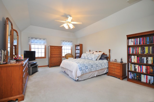 bedroom featuring a raised ceiling, baseboards, and light carpet