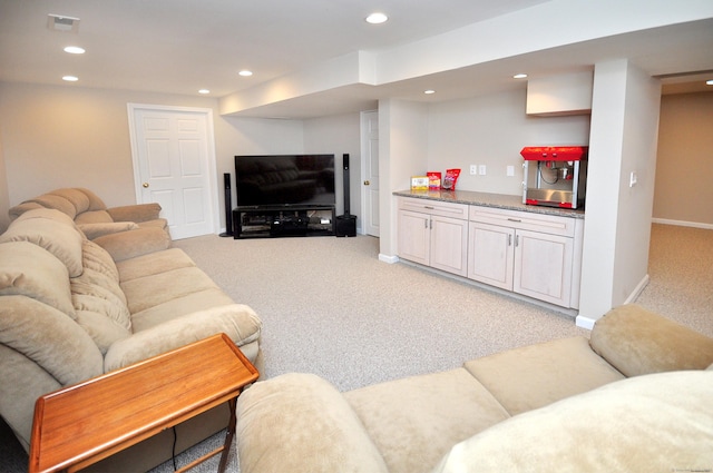 living room featuring recessed lighting, light colored carpet, baseboards, and visible vents