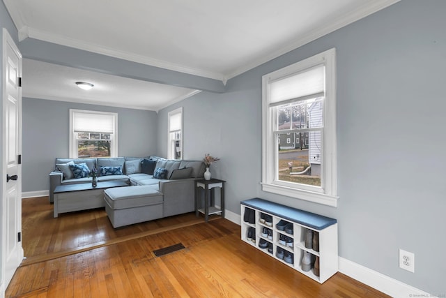 living area featuring hardwood / wood-style flooring, baseboards, and a wealth of natural light