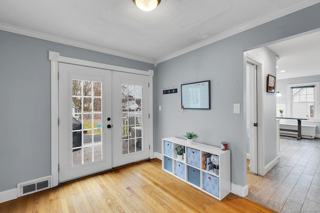 doorway to outside featuring visible vents, wood finished floors, crown molding, and french doors