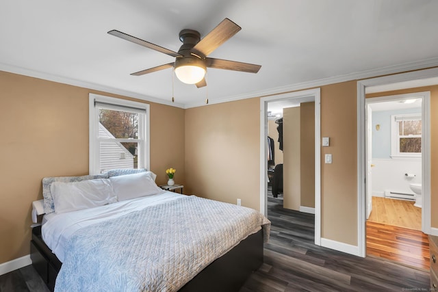 bedroom featuring a baseboard radiator, dark wood-style flooring, a spacious closet, a closet, and crown molding