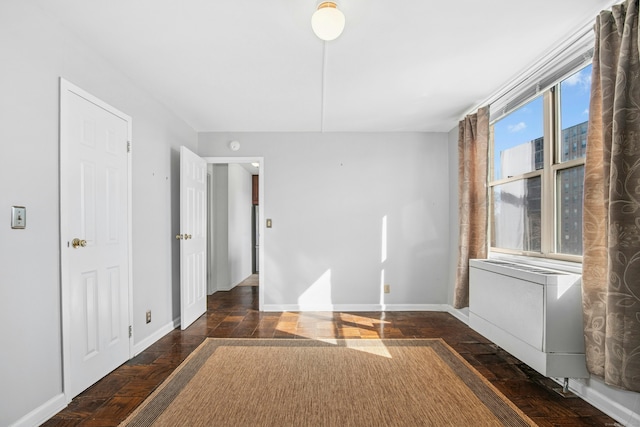 spare room featuring baseboards