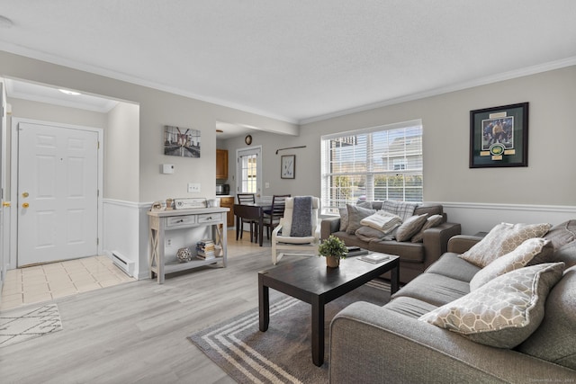 living area with light wood-style flooring, baseboard heating, and ornamental molding