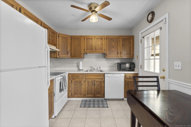 kitchen with white appliances, light tile patterned floors, a ceiling fan, a sink, and under cabinet range hood