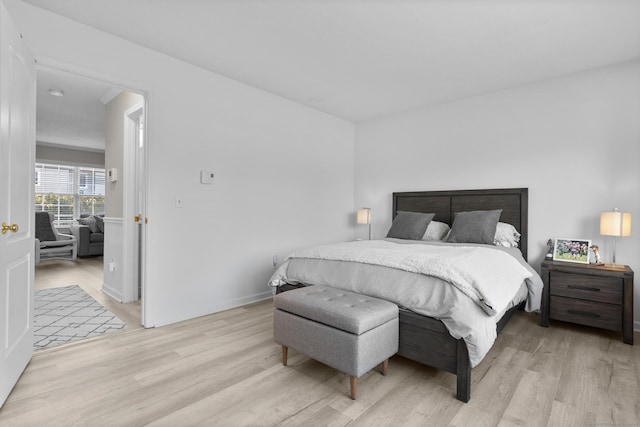 bedroom featuring light wood-style floors and baseboards