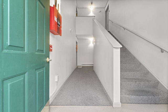 stairs featuring baseboards, carpet floors, and a baseboard radiator