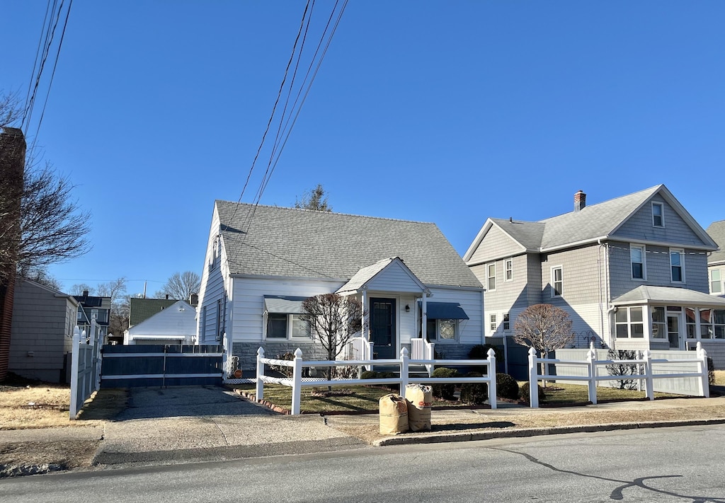 84 Glendale Ave, Bridgeport, CT 06606 - view of front of property featuring a fenced front yard, roof with shingles, and a chimney