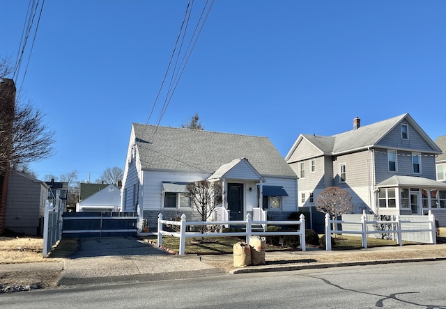 84 Glendale Ave, Bridgeport, CT 06606 - view of front of property featuring a fenced front yard, roof with shingles, and a chimney