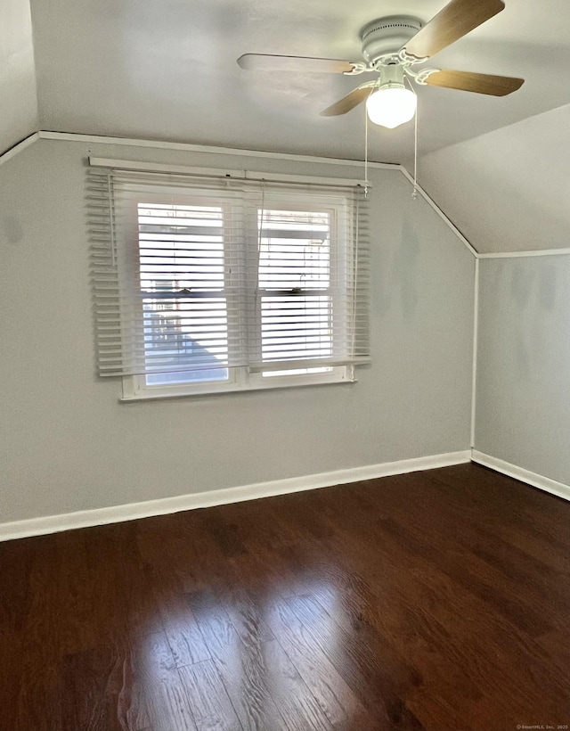 bonus room with lofted ceiling, wood finished floors, baseboards, and ceiling fan