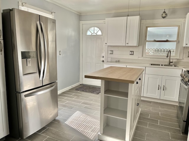 84 Glendale Ave, Bridgeport, CT 06606 - kitchen featuring stainless steel refrigerator with ice dispenser, butcher block counters, a sink, ornamental molding, and white cabinets