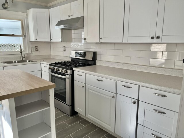 84 Glendale Ave, Bridgeport, CT 06606 - kitchen with under cabinet range hood, gas stove, a sink, white cabinetry, and tasteful backsplash