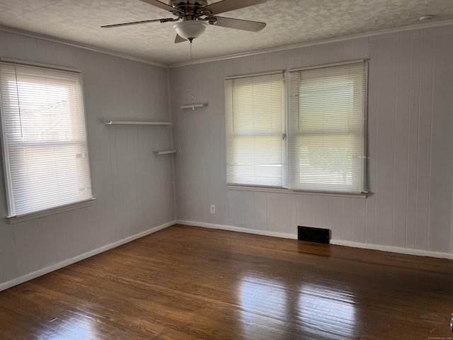 84 Glendale Ave, Bridgeport, CT 06606 - spare room with wood-type flooring, ceiling fan, baseboards, wood walls, and ornamental molding