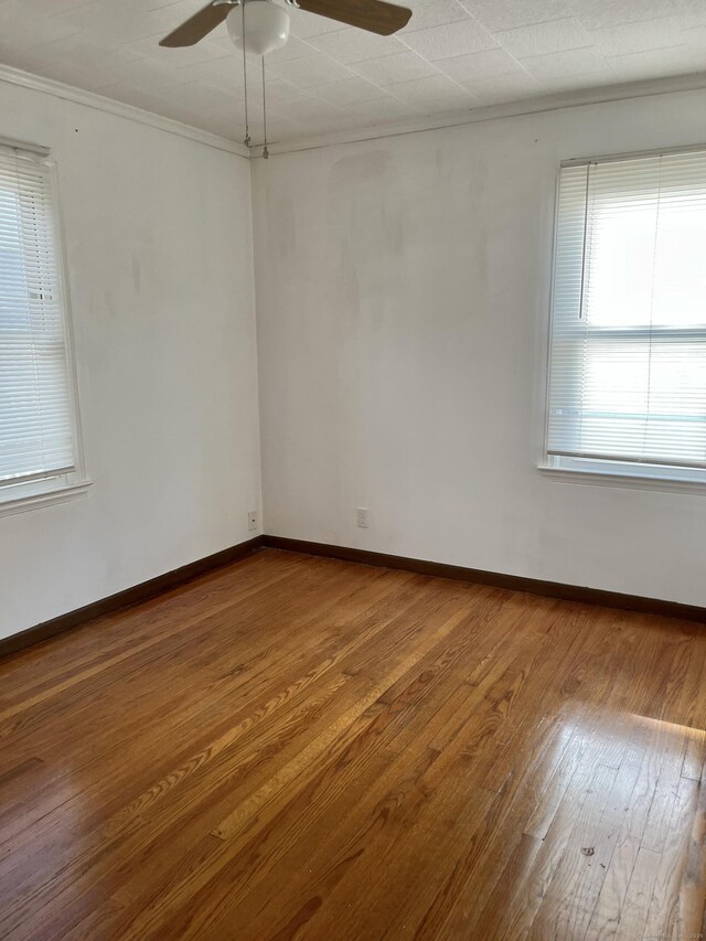 84 Glendale Ave, Bridgeport, CT 06606 - unfurnished room featuring a ceiling fan, crown molding, wood-type flooring, and baseboards