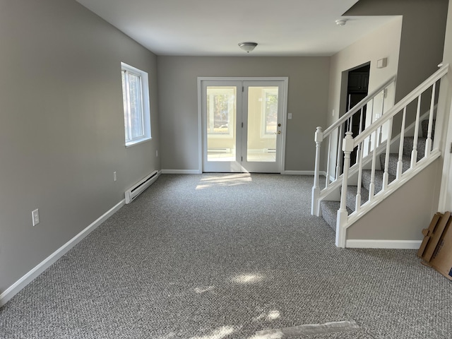 entryway featuring a baseboard heating unit, baseboards, carpet, and stairway