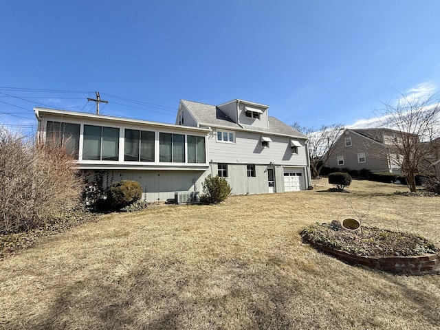 back of property featuring central AC, an attached garage, and a sunroom