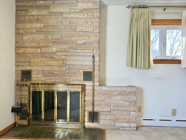 details featuring baseboard heating, a stone fireplace, and visible vents