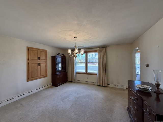 unfurnished dining area with a baseboard heating unit, arched walkways, an inviting chandelier, and light carpet