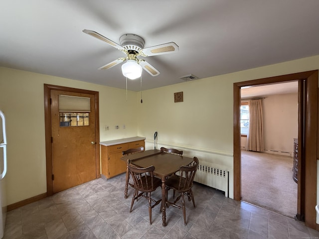 dining space featuring radiator, baseboards, visible vents, carpet floors, and ceiling fan