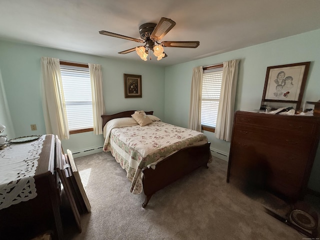 carpeted bedroom featuring multiple windows, baseboard heating, and ceiling fan