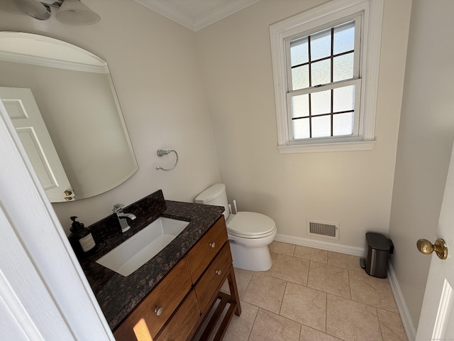 bathroom featuring visible vents, baseboards, toilet, and crown molding