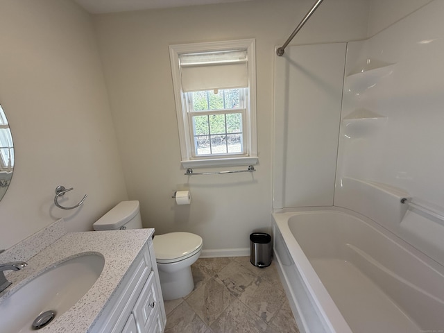 bathroom with vanity, toilet, bathtub / shower combination, and baseboards