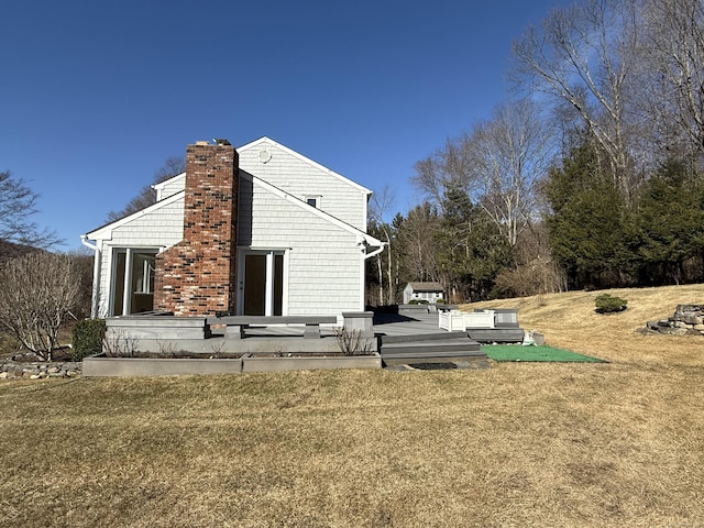 exterior space with a yard and a chimney