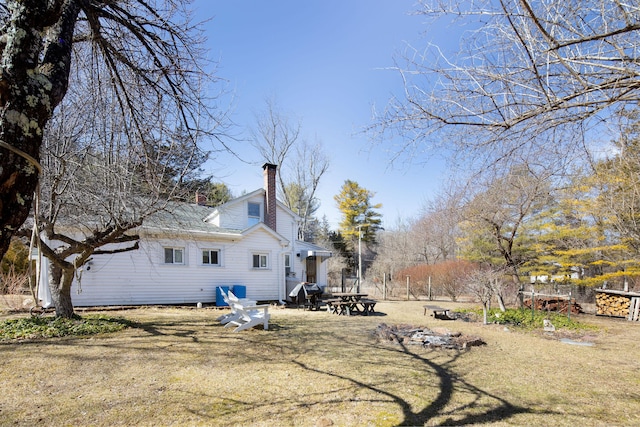 rear view of house featuring a chimney