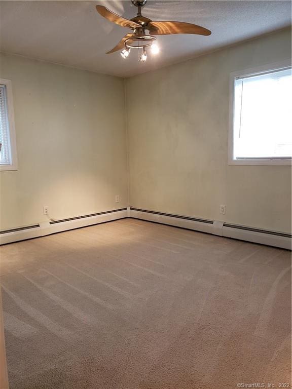 carpeted spare room featuring ceiling fan