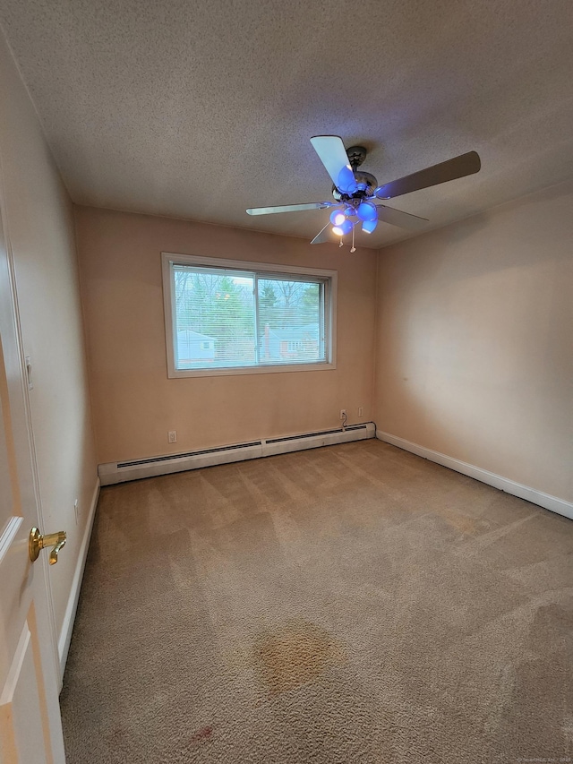 spare room with a baseboard heating unit, baseboards, carpet flooring, a textured ceiling, and a ceiling fan