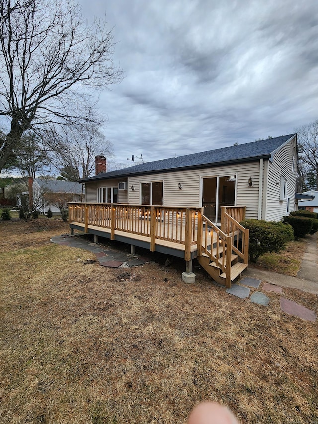 back of property featuring a deck and a chimney