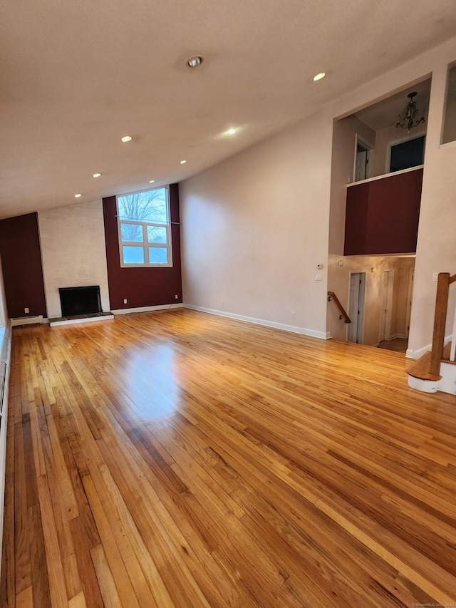 unfurnished living room with recessed lighting, a fireplace, baseboards, and light wood-style floors