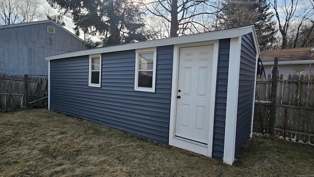 view of outbuilding featuring an outbuilding and fence