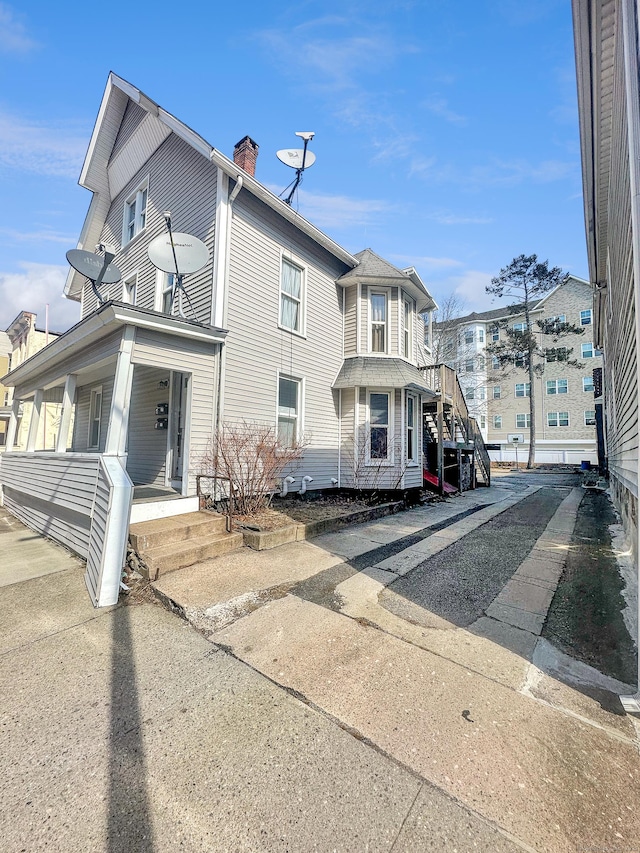 63 Minerva St, Derby, CT 06418 - view of front of house featuring covered porch and a chimney