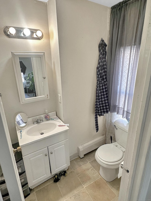 63 Minerva St, Derby, CT 06418 - half bath with a baseboard heating unit, toilet, and vanity