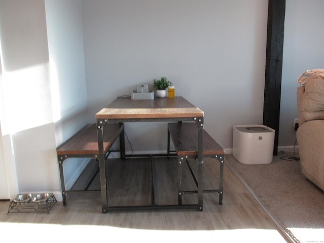 interior space with baseboards and wood finished floors