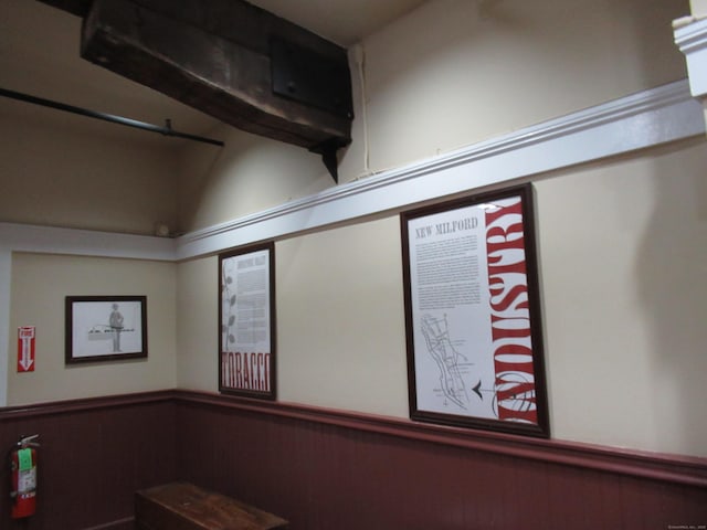 room details featuring wainscoting and a fire extinguisher