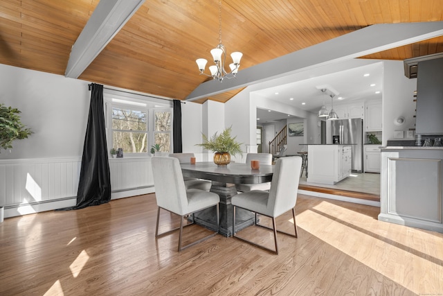 dining room with a baseboard heating unit, wood ceiling, light wood-type flooring, lofted ceiling, and an inviting chandelier