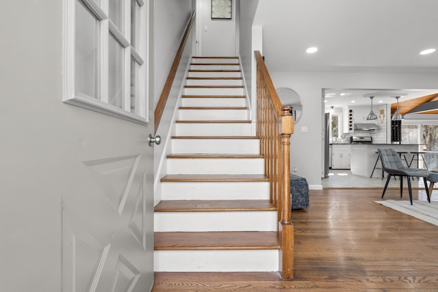 stairway featuring recessed lighting, baseboards, and wood finished floors