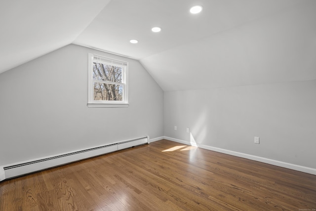 bonus room with wood finished floors, baseboards, a baseboard radiator, recessed lighting, and vaulted ceiling