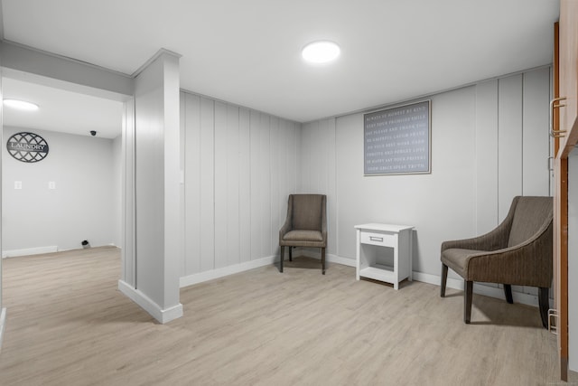 sitting room with light wood-type flooring and baseboards