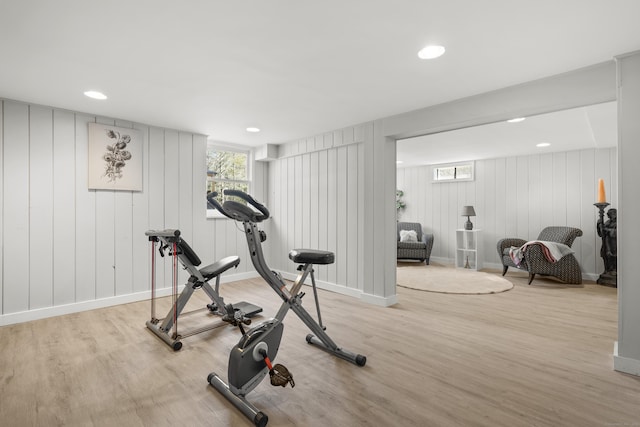 workout room featuring recessed lighting, baseboards, and light wood-style floors