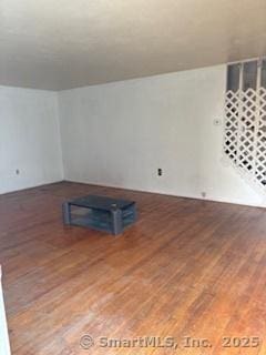 unfurnished living room featuring wood finished floors
