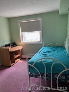 carpeted bedroom with a baseboard heating unit