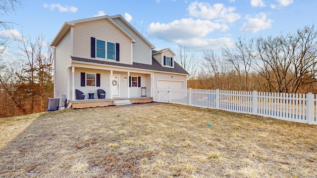 traditional-style home featuring a front yard, a porch, an attached garage, and fence