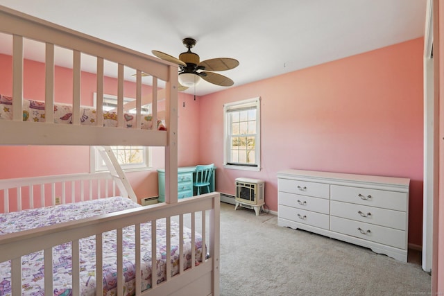 carpeted bedroom with a baseboard heating unit, ceiling fan, and a baseboard radiator