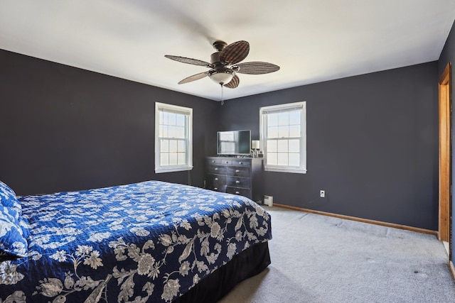 carpeted bedroom featuring baseboards and ceiling fan