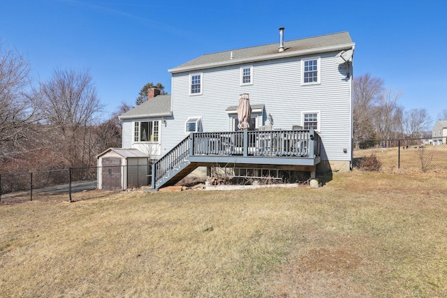 back of house with stairway, a yard, a fenced backyard, a chimney, and a deck