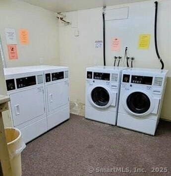 community laundry room with washing machine and clothes dryer