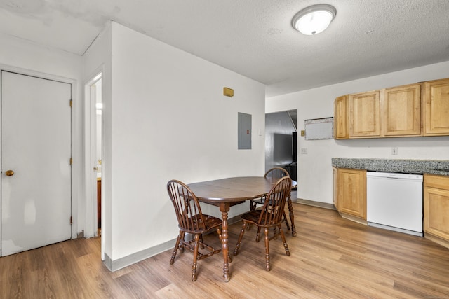 dining room featuring electric panel, baseboards, a textured ceiling, and light wood finished floors